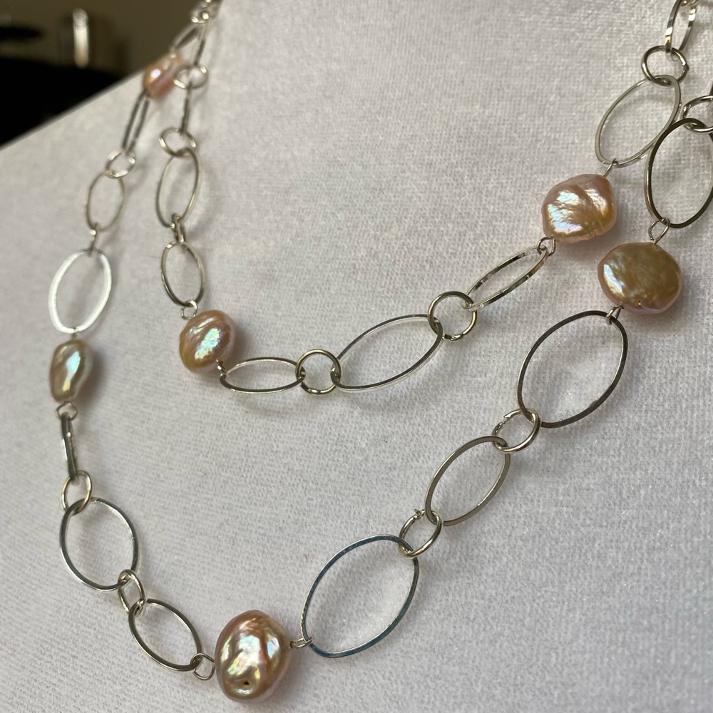 Long silver tone and freshwater pearl necklace.  Perfect condition